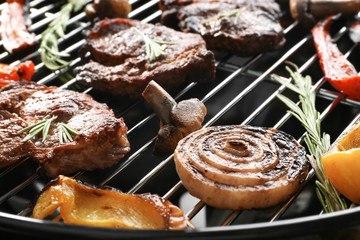 Tasty steaks and vegetables on barbecue grill, close up