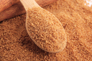 Wooden spoon with sweet cinnamon sugar, closeup