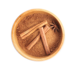 Wooden bowl with sweet cinnamon sugar on white background