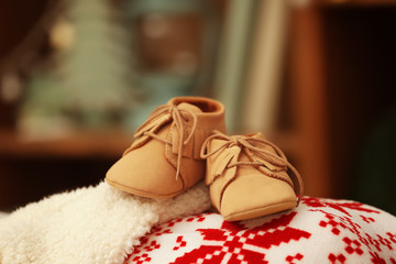 Baby booties on blurred background. Christmas concept