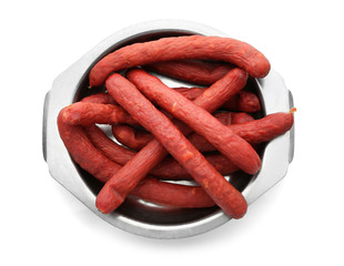Plate with smoked sausages on white background