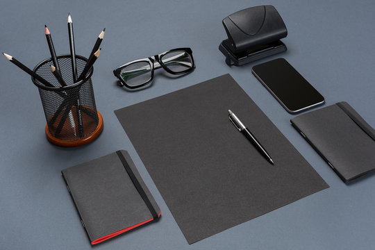 Black office stuff collection flat lay. Top view on set of stationery with smartphone