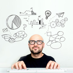 Portrait view of an attractive dubious geek with business icons surrounding his head - Business concept