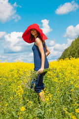 happy woman in a red hat with a bouquet of wildflowers