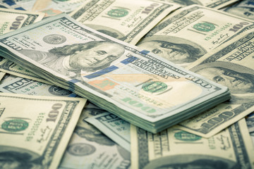 Lot of one hundred dollar bills close-up background