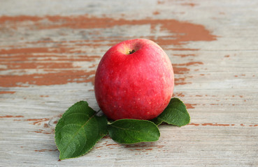 red apple on an old wood table