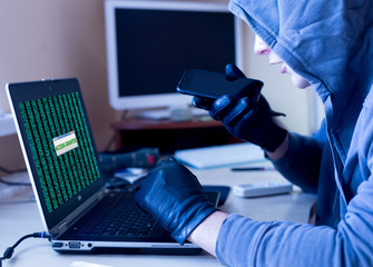 Computer Hacker claiming his demands to victim using mobile telephone