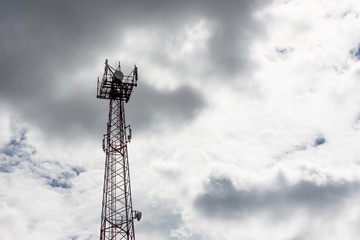 Telecommunication mast / tower with microwave link and TV transmitter antennas with dramatic clouds in the sky. Concept lack of cellular communication due to weather conditions