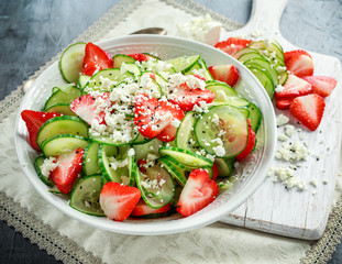Summer Cucumber and strawberry salad topped with nigella seeds and feta cheese
