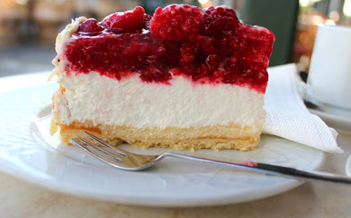 Slice of cheesecake with fresh raspberries 