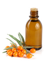 Sea-buckthorn oil with berries and leaves isolated on white background