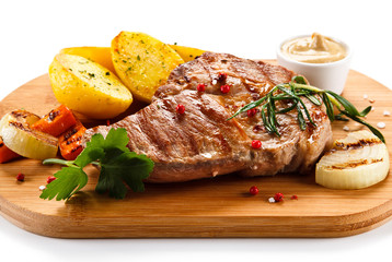 Steaks, baked potatoes and vegetable salad