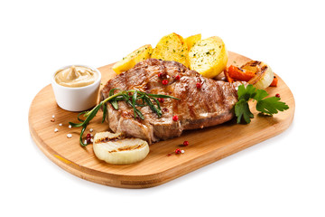 Steaks, baked potatoes and vegetable salad