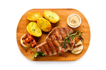Steaks, baked potatoes and vegetable salad