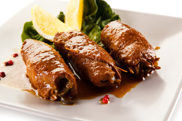 Wrapped pork chops on white background