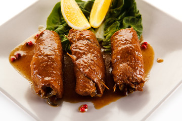 Wrapped pork chops on white background