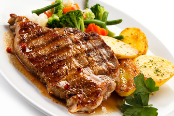 Grilled beefsteak with broccoli and carrot on white background