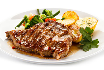 Grilled beefsteak with broccoli and carrot on white background