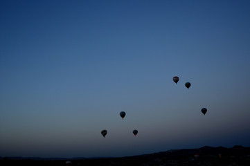 ballooning. A balloon flies in the sky in the rays of the rising sun. A bright sky, a haze, an extinct volcano on the horizon.