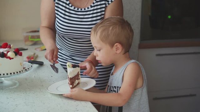 The woman puts the cake in the dish to children