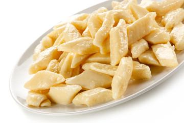 Potato noodles - dumplings on white background