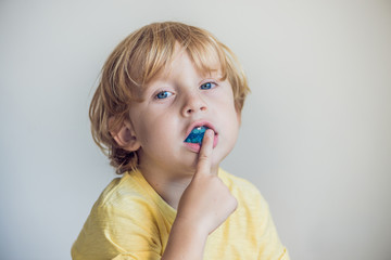 Three-year old boy shows myofunctional trainer to illuminate mouth breathing habit. Helps equalize...