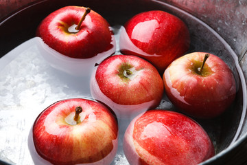 Metal basin with apples in water. Autumn harvest background
