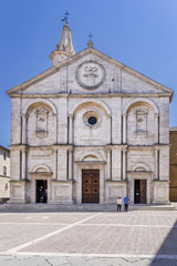 Fototapeta na wymiar The stunning facade of the Duomo di Santa Maria Assunta cathedral, Pio II square, in the historic center of Pienza, Siena, Italy on a sunny day