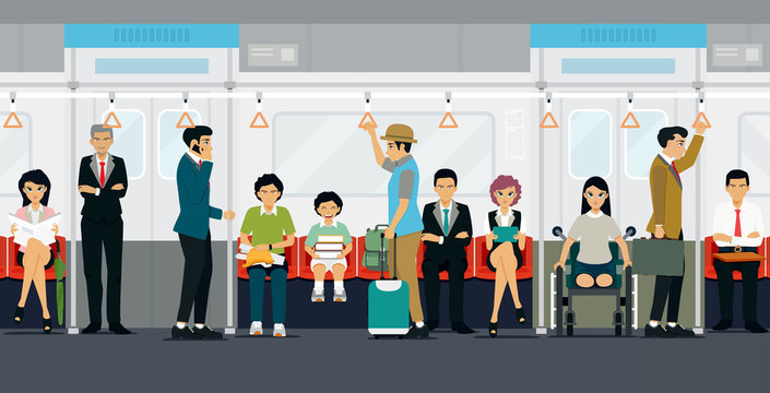 People stand and sit on the subway train.