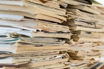 A stack of old school notebooks. Multicolored cover.