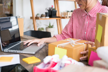 business owner packing cardboard box at workplace. freelance woman seller prepare parcel box of product for deliver to customer.  Online selling, internet marketing, e-commerce, shipping concept