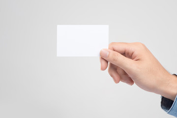 Obraz premium Male hand holding blank business card isolated