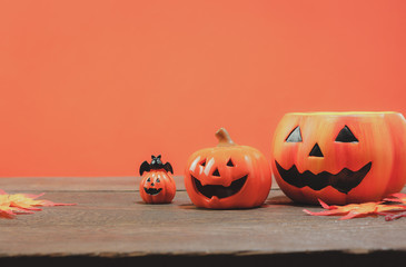 Items or Happy Halloween festival concept.The essential several accessory for the season.Head jack lantern and mix variety object on the modern rustic brown and the orange wallpaper background.