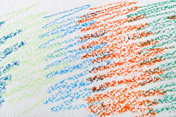 Child painting in wax crayon on white paper