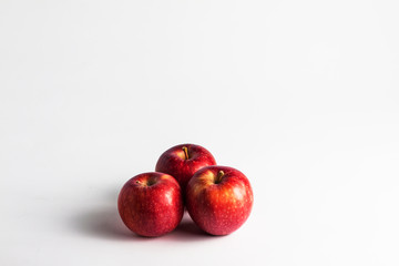close-up view of fresh red apples on a white background