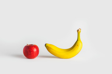 close-up view of a banana an apple on a white background