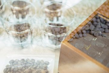 glass of coffee for taster to smell and taste aromatic and flavor wheel. aroma perception in brewed coffee double exposure with roasted bean. cupping examination.