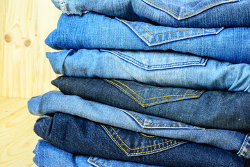 Jean denim on wooden table background.