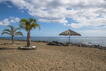 Obraz na płótnie Canvas Spiaggia con palme e ombrellone