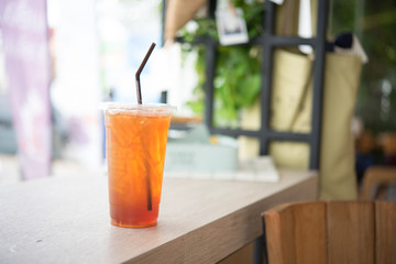 a cup of ice tea put near the window