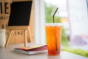 a cup of ice tea put near the window