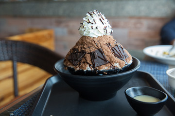 Korean bingsu Chocolate flavour or ice dessert snow flake with fresh with chocolate and whip cream topping.