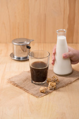 Coffee with milk on a wooden table.