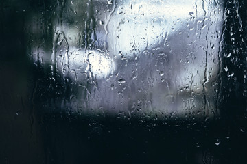 Naklejka na ściany i meble Rain drops on window glasses in Rainy Day