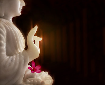 White Buddha wiith flower, Buddha blessing pose