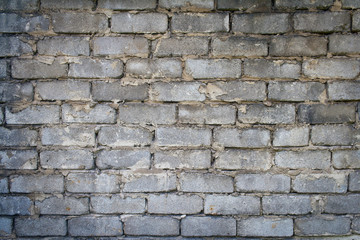 Grey brick wall texture background. Tiled.