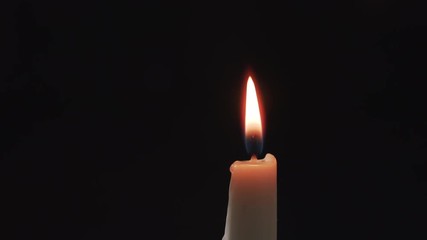 ighting tall candle with another candle in the dark