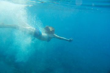 Woman swimming underwater