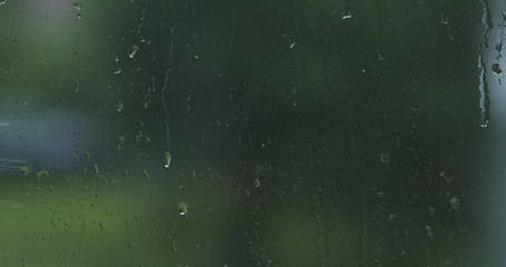 first rain drops on dirty window