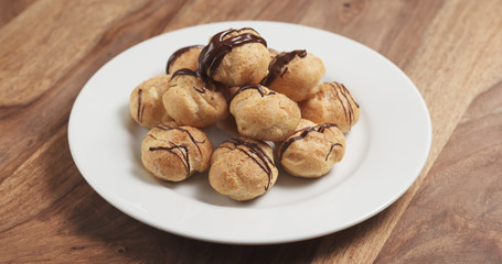 profiteroles with fine dark chocolate on plate
